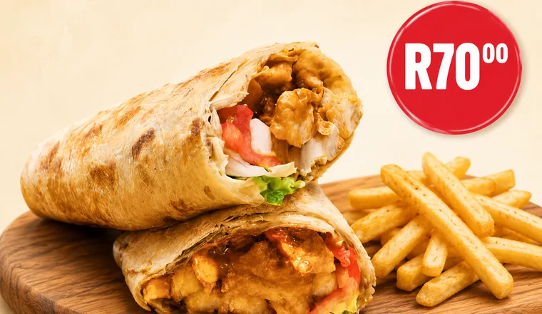 Butter chicken salomie wrap with spicy chips on a wooden board — Parks Pizza & Take-Aways R70 special in Kensington, Cape Town